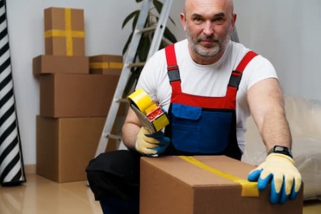 man-mover-in-uniform-packing-boxes-with-scotch-tap-2025-02-25-16-07-31-utc.jpg